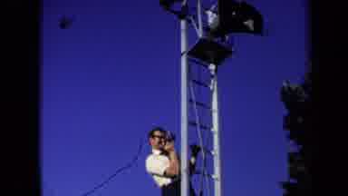 Sacramento California USA (1971): A Photographer On A Tall Ladder Trying To Take A