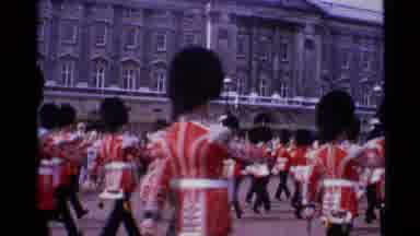 London England (1969): Many Officers In Red Holding A Flag Is Marching In The