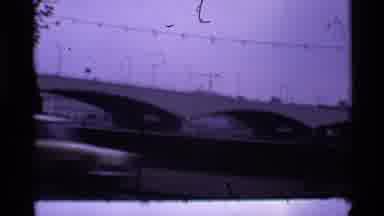 London England (1969): Still Shot Of Bridge With Car Zooming Past The Lens