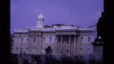 London England (1969): Historic Building On A Cloudy Day With Cars Passing