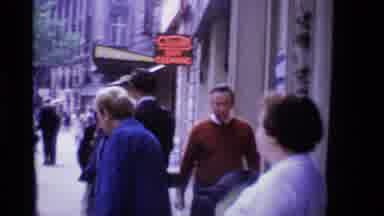 London England (1969): A Man Walks Down The Sidewalk Next To Some People And Women