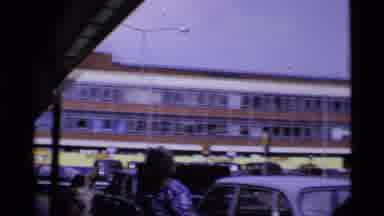 London England (1969): Videographer Filming The City Life As A Red Car Drives By