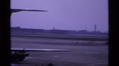 London England (1969): Back Of Plane Zoomed Out Towards A Plane Taking Air