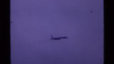London England (1969): Airplane Flying Above Suddenly Begins To Drop Trail Of