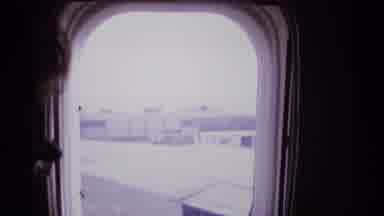 London England (1969): Person Sees A Train Go By Through Airplane Window As Plane