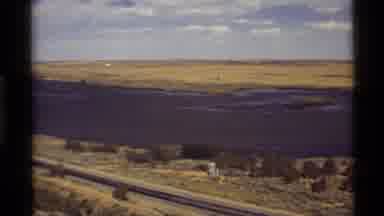 Holland Lake Montana USA (1972): A Car Driving On A Highway By The River