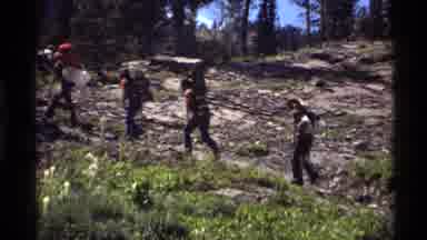 Holland Lake Montana USA (1972): Group Of Individuals Hike Up Sloping Rocky Hill