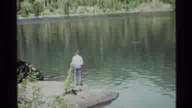 Holland Lake Montana USA (1972): A Man St As Nding Alone Enjoying The View Of The