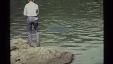 Holland Lake Montana USA (1972): White Man In Jeans Standing On A Rock Fishing In