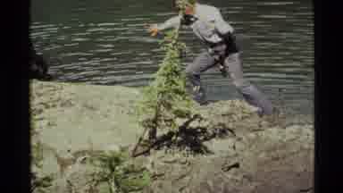 Holland Lake Montana USA (1972): Fisherman Tries To Navigate Wet Rocks And Takes A