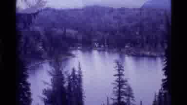 Holland Lake Montana USA (1972): View Of Trees Lake And Mountains On A Cloudy Day