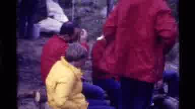 Holland Lake Montana USA (1972): Six People Around Campfire In The Woods On A Cold