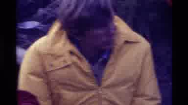 Holland Lake Montana USA (1972): People Gathered Around A Campfire Wearing Warm