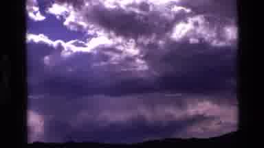 Idaho USA (1972): Sky Filled Full Of White Clouds With The Sun Sneaking Through A