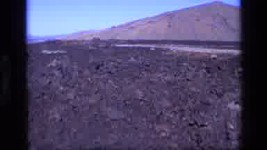 Idaho USA (1972): Barren Landscape With Lava And Mountains Possibly In Hawaii