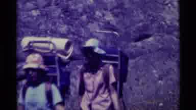 AGATE SPRINGS MONTANA USA-1975: Three Hikers Trekking Through Dry Terrain Past Big Boulders