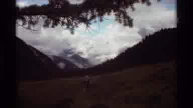 Agate Springs Montana USA (1975): Looking Through Trees At A Cloudy Mountain