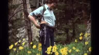 Agate Springs Montana USA (1975): Hiker Putting On Backpack On A Flowery Hill Or