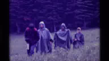 Agate Springs Montana USA (1975): Five People Trudging Up A Hill In The Rain