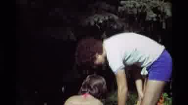 Agate Springs Montana USA (1975): Man Bending Down Next To Squatting Girl In