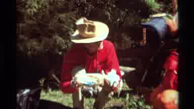 Agate Springs Montana USA (1975): A Man In A Read Shirt And A Hat Passing Bread To