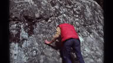 Agate Springs Montana USA (1975): A Person Wearing A Red Weather Vest Climbing A