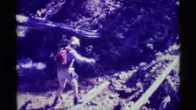 Agate Springs Montana USA (1975): Hiker In Backpack Crosses Log And Joins Others