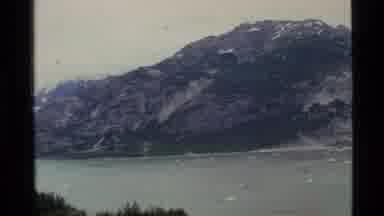Alaska USA (1977): Glacier River Flowing And Mountains With Show On Top In The