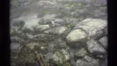 Alaska USA (1977): Three People Hiking Through A Rock Filled Pass Up A Snowy