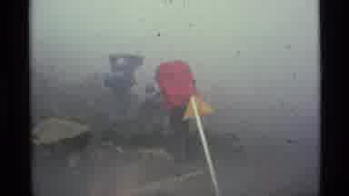 Alaska USA (1977): People Climbing Up Big Rocks With Heavy Backpacks In Foggy
