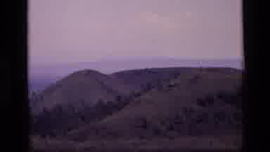 Idaho USA (1972): Hikers Hiking Up A Mountain While The Camera Pans To A Giant