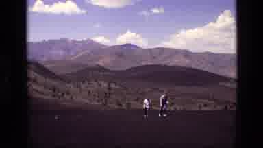 Idaho USA (1972): Two Hikers Walking Up And Down A Mountain Peak Area