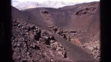 Idaho USA (1972): Camera Pans Across A Brown And Black Volcanic Looking Mountain