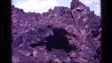 Idaho USA (1972): Rocky Cave Entrance On Hillside With Scenic View Of Mountain In