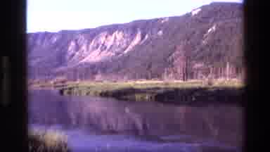 Idaho USA (1972): A View Of Isolated Mountain Peak Surrounded By Water