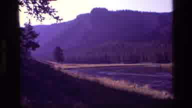 Idaho USA (1972): Grainy Video Of Several Mountains And Trees Panning Over A Lake