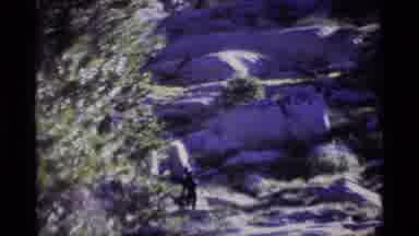 MINARET WILDERNESS CALIFORNIA USA .M-1975: Couple Slowly Hiking Along Rocky