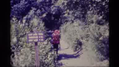 Alaska USA (1977): Hikers Carrying Large Rucksacks Walking Down Footpath In Rural
