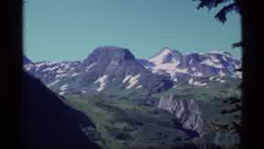 Alaska USA (1977): A Mountain With Some Snow On Top And Lush Grasses Below It And