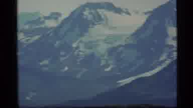 Alaska USA (1977): Snowy Mountains Viewed From A Green Foreground Slowly Zooming