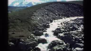 Alaska USA (1977): Melting Snow Creates A Gentle Stream Off The Mountain Range