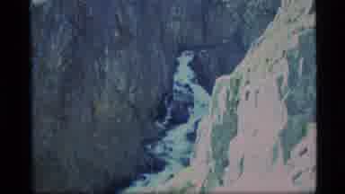 Alaska USA (1977): A Stream Of Whitewater Winds Down A Mountain Gorge With Sheer
