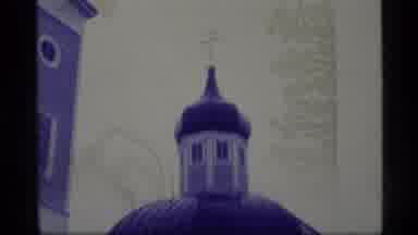Alaska USA (1977): Buildings One With A Cross On The Top Of It And There Is Water