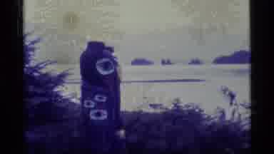 Alaska USA (1977): Totem Pole In Forested Land Overlooking Bay With Islands And