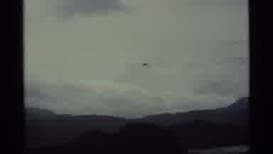 Alaska USA (1977): Seaplane Flying Over Mountains Getting Ready To Land In A Lake