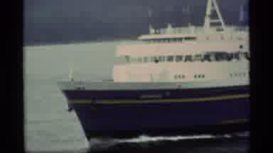 Alaska USA (1977): Cruise Ship Sails In Front Of Green Hills On A Foggy Day