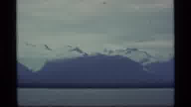Alaska USA (1977): Snow Covered Mountains In The Distance With A Lake In Front