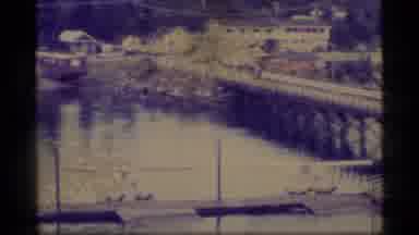 Alaska USA (1977): A Ship In A River And 2 Small Aircraft Beached Next To A Small