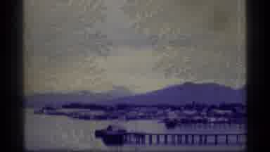 Alaska USA (1977): Boat Sails Across The Water That Is Nestled Between Two