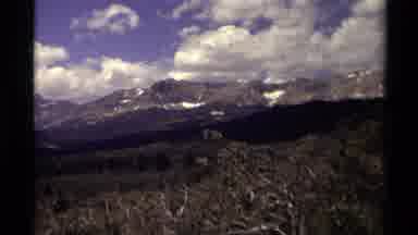 Canada (1979): Panning View Of Rugged Mountain Range With Blue Sky And White